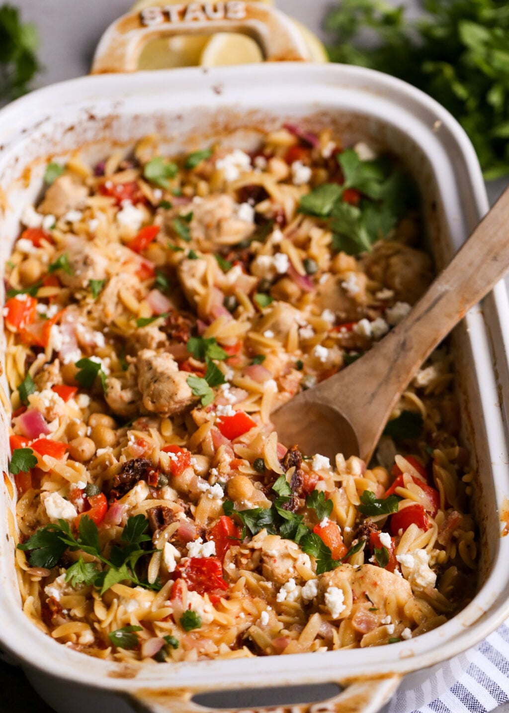 Mediterranean chicken orzo casserole with feta, chickpeas, tomatoes, and herbs, an easy one-pan dinner recipe.