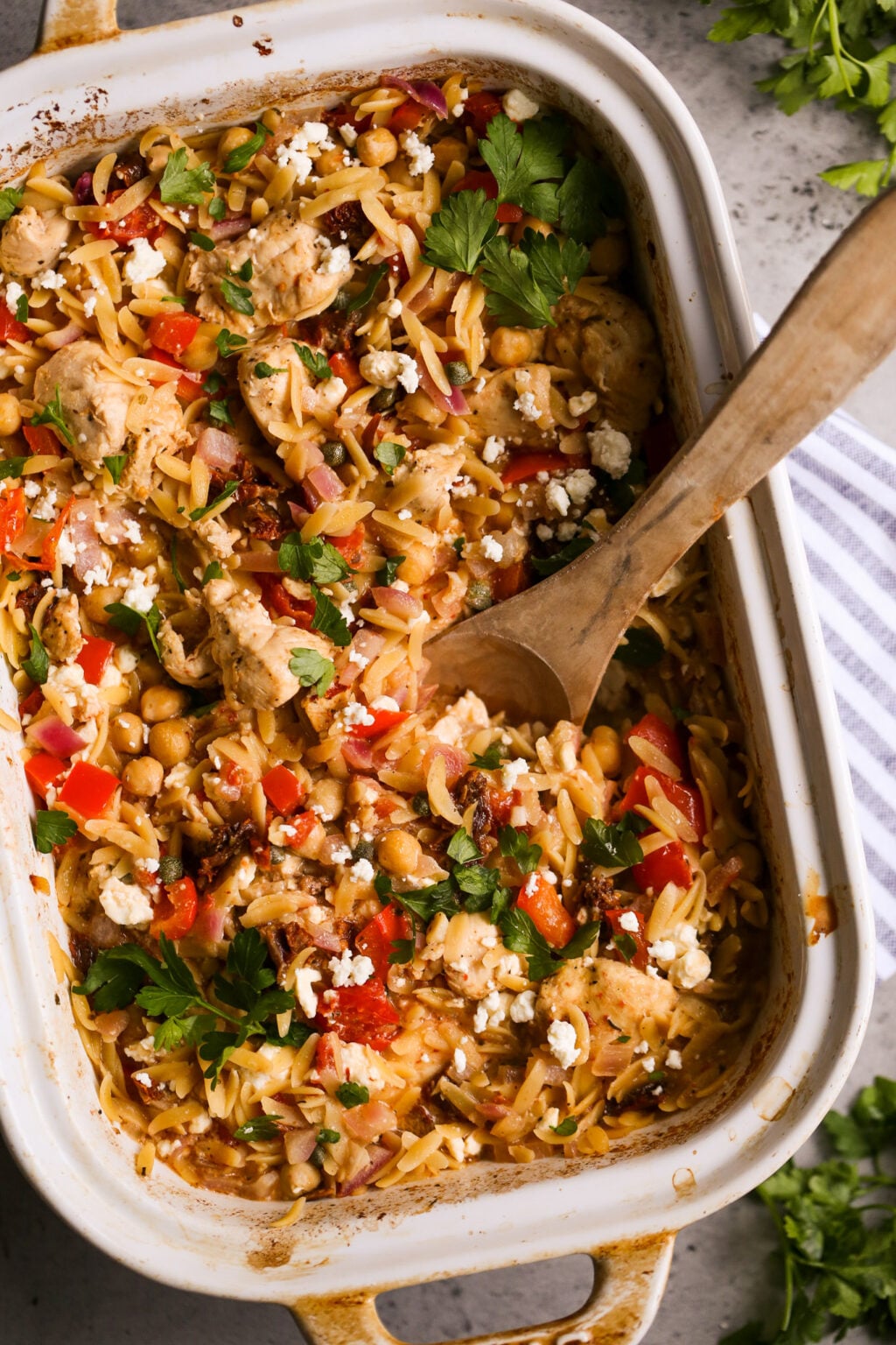 Easy Mediterranean chicken orzo casserole with tomatoes, chickpeas, feta, and fresh herbs—perfect one-pan dinner recipe.