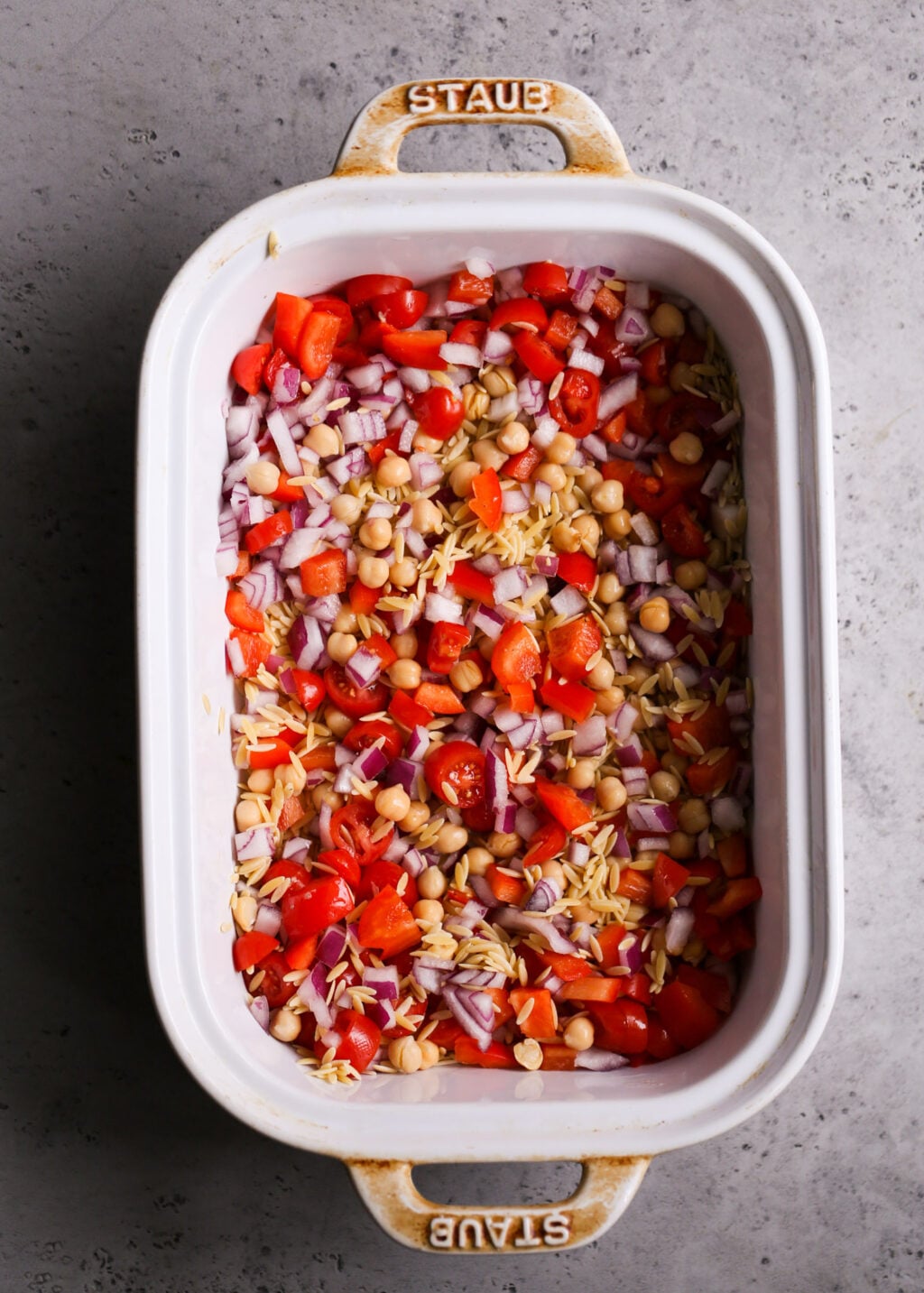 Easy Mediterranean chicken orzo casserole with chickpeas, tomatoes, red onions, and peppers, perfect healthy one-pan dinner.