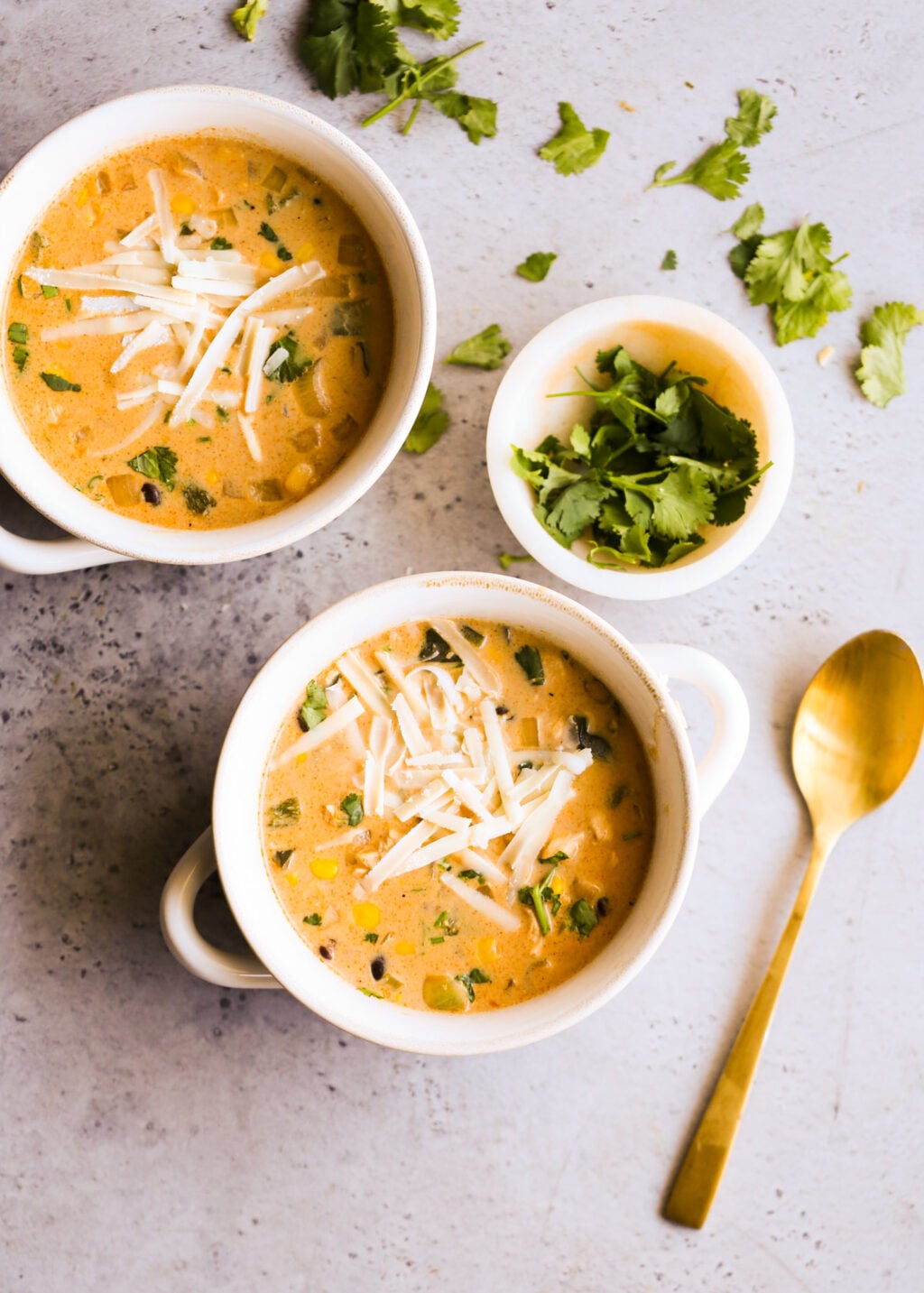 Creamy easy chicken poblano soup with corn and cilantro, topped with shredded cheese—perfect dinner.