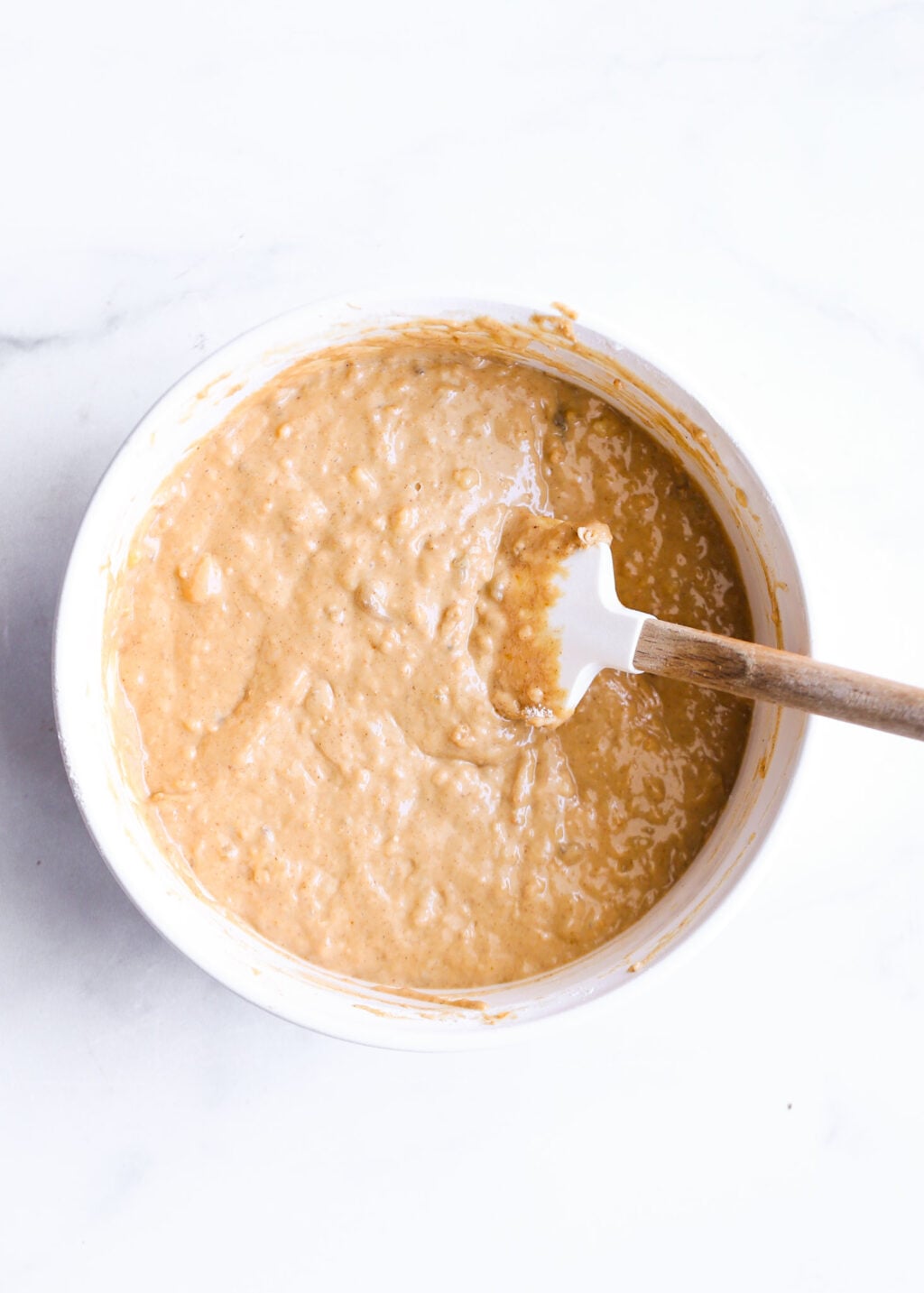 High-protein peanut butter banana bread batter in a bowl with spatula - easy healthy banana bread recipe using Greek yogurt