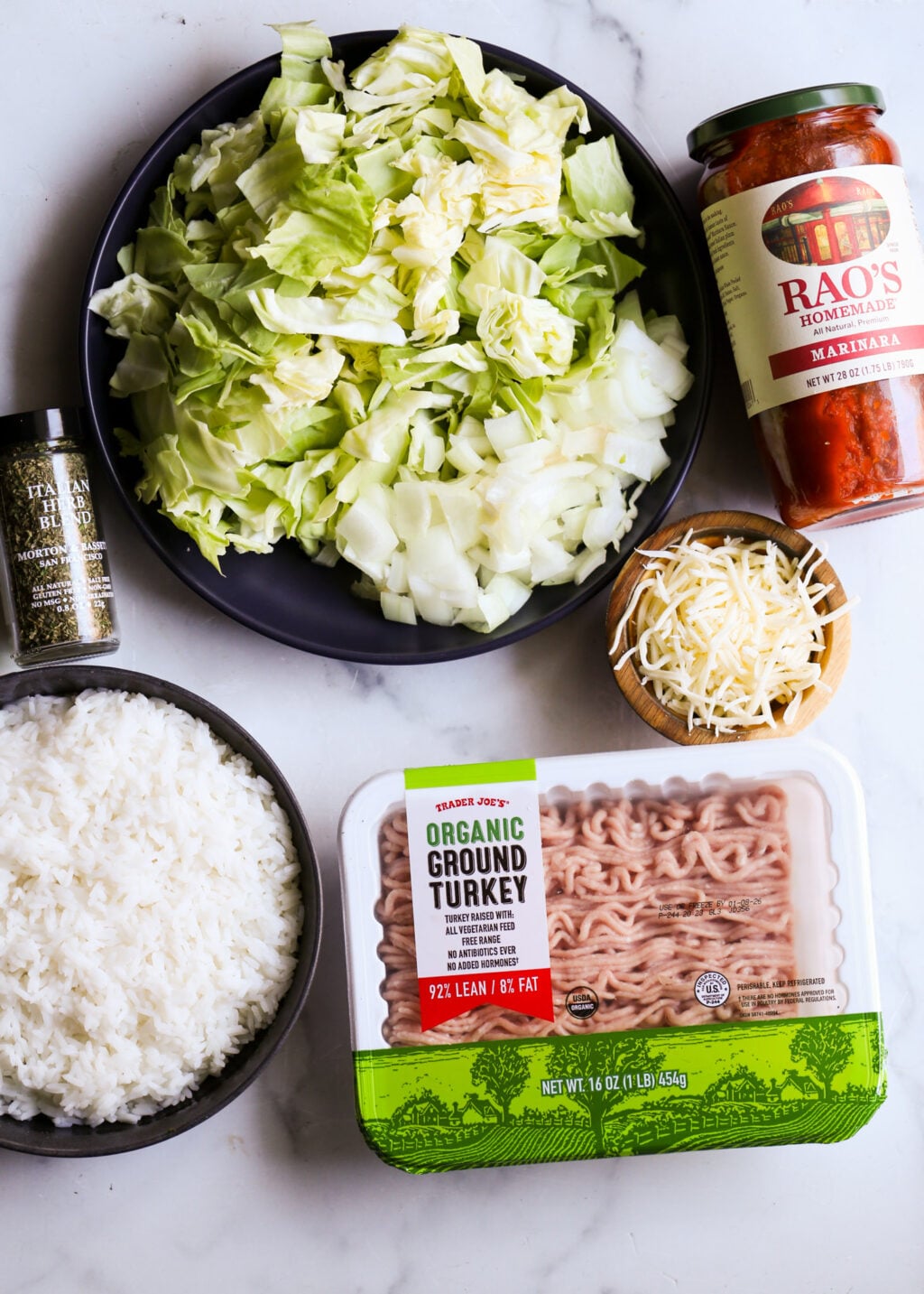 Easy unstuffed cabbage casserole ingredients: chopped cabbage, ground turkey, marinara sauce, rice, shredded cheese for dinner.