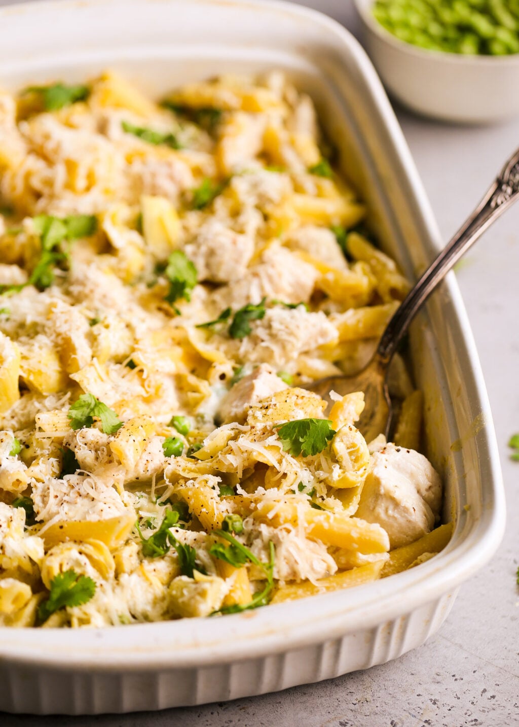 Creamy no-boil chicken pasta casserole with artichokes and peas, cheese and herbs - dump-and-bake recipe