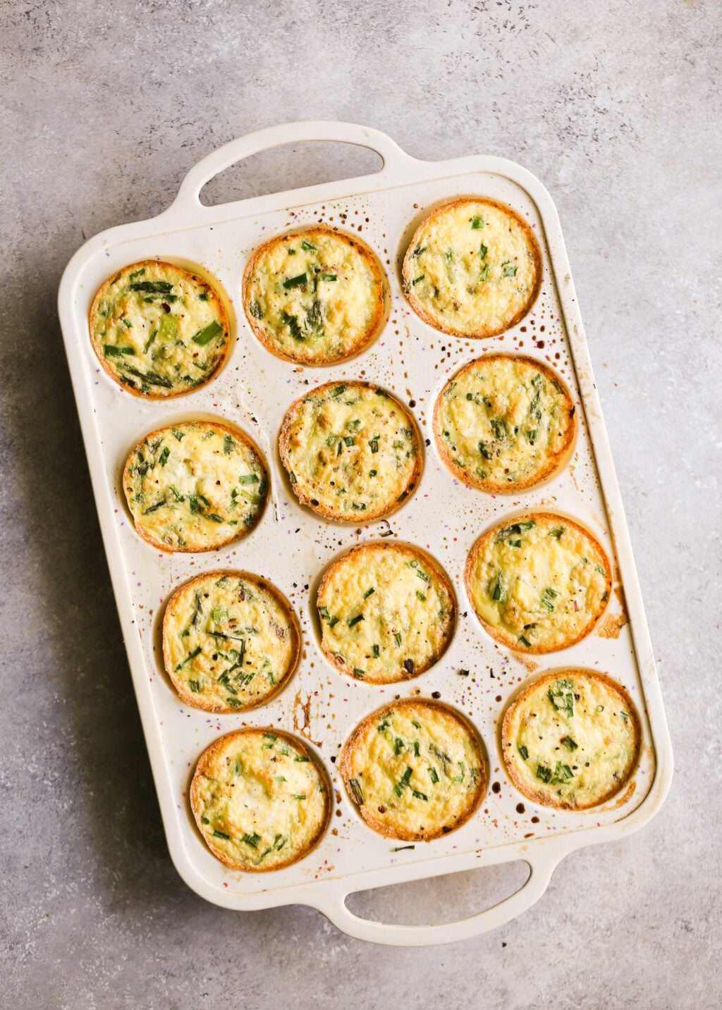 Egg muffins with asparagus and feta baked in a 12-cup muffin pan—high-protein meal prep recipe, oven-baked.