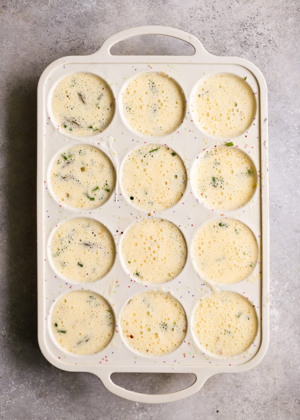 Asparagus and feta egg muffins baked in a 12-cup muffin tin, high-protein breakfast meal-prep bites.