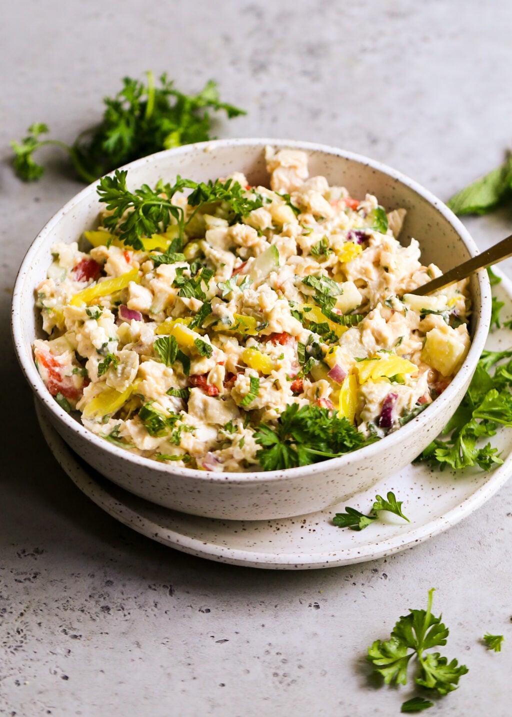 Creamy Mediterranean chicken salad with shredded chicken, mashed chickpeas, feta, peppers, cucumber, red onion and herbs (no mayo).