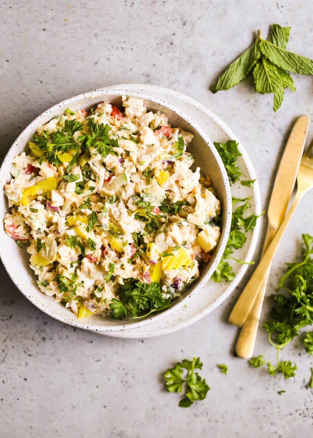 Creamy Mediterranean chicken salad with shredded chicken, mashed chickpeas, feta, peppers, cucumber, red onion and herbs (no mayo).