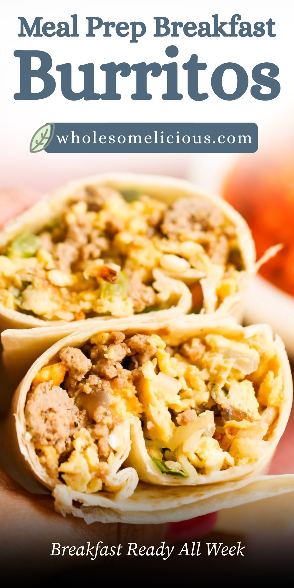 Close up of two meal prep breakfast burritos cut in half to show a hearty filling of turkey sausage, scrambled eggs, sweet potatoes, spinach, and melted cheese wrapped in soft tortillas. This healthy freezer breakfast burrito recipe is perfect for meal prep, grab and go breakfasts, and busy weekday mornings.